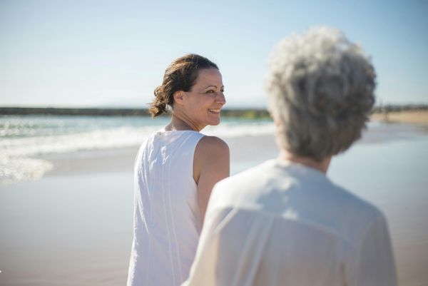 a woman and her mother at the beach